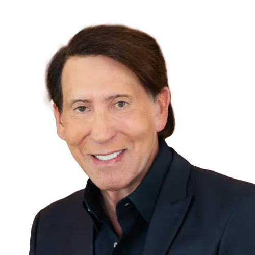 A middle-aged man with light skin, straight brown hair, and brown eyes is smiling at the camera. He is wearing a black blazer over a black collared shirt. The background is plain and has been removed, making the image appear cut out.