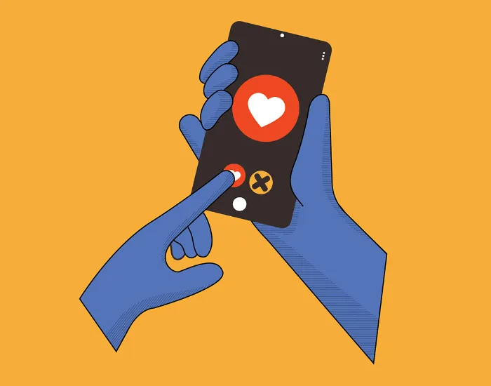 Illustration of two blue hands holding a smartphone. One hand holds the phone, showing a heart icon and an "X" icon on the screen, while the other hand’s finger presses the heart, symbolizing liking or swiping right on a dating app. The background is orange.