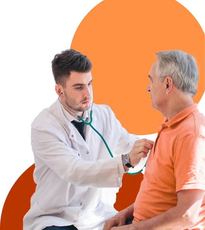 A young male doctor in a white coat uses a stethoscope to listen to the chest of an older man in an orange polo shirt. Both are seated and facing each other. The background features abstract orange shapes.