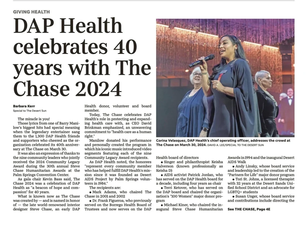 A newspaper article titled “DAP Health celebrates 40 years with The Chase 2024” features a large photo of five people on stage. A woman sings into a microphone while four others, three women and one man, stand together smiling, holding mics and papers.