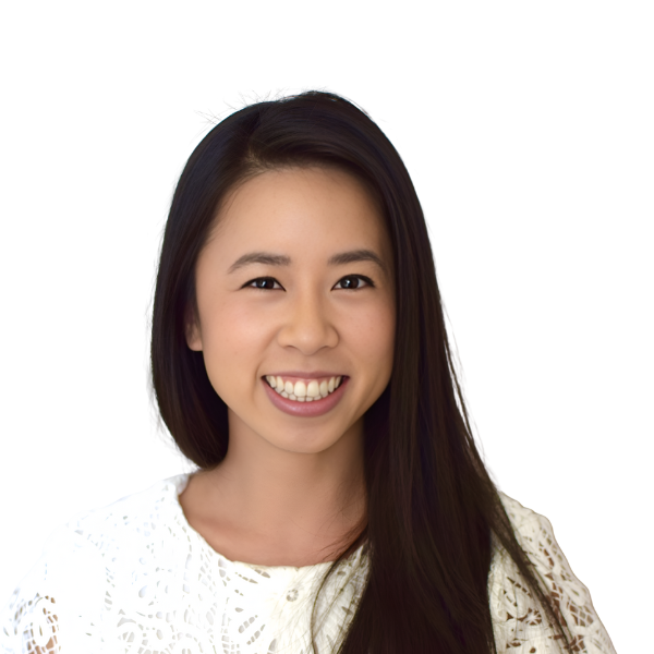 A young woman with long, straight dark hair smiles warmly. She wears a white, lace-patterned top. The background is plain and light, making her the clear focus of the image.